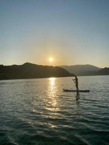a person on a paddle board in the water at Lejla apartmani - Jablaničko jezero in Konjic