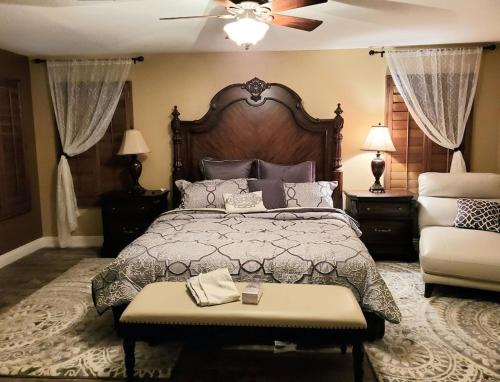 a bedroom with a large bed and a ceiling fan at Stunning Strip and Mountain Views in Las Vegas in Las Vegas