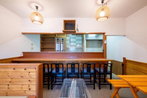 a dining room with wooden tables and chairs at VILLENT KUJUKURI MARINE in Kujukuri