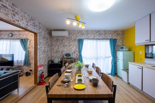 a dining room table with chairs in a kitchen at VILLENT KUJUKURI MARINE in Kujukuri
