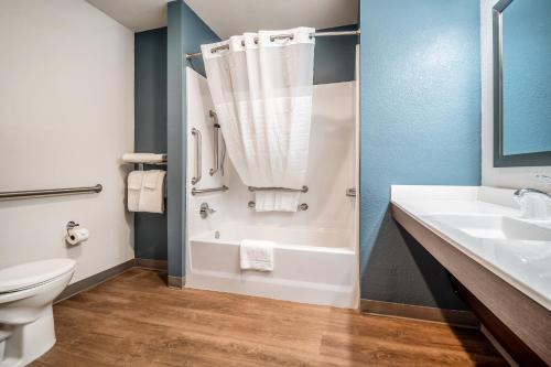 a bathroom with a tub and a sink and a toilet at WoodSpring Suites Jacksonville - South in Jacksonville