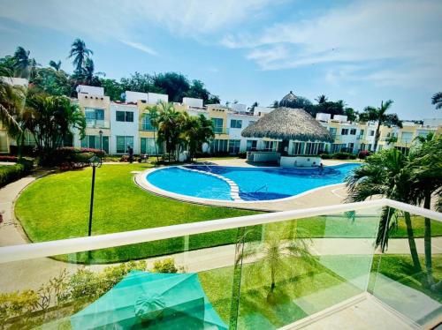 a view from the balcony of a resort with a swimming pool at NUEVO EN BOOKING CASA TERRANIUM ACAPULCO DIAMANTE in Acapulco