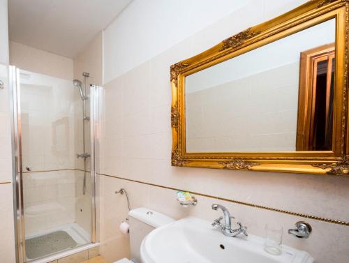 a bathroom with a toilet and a sink and a mirror at Hamlet Bed & Breakfast in Dubrovnik