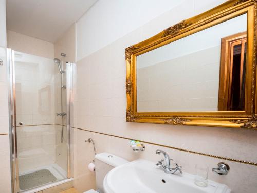 a bathroom with a toilet and a sink and a mirror at Hamlet in Dubrovnik