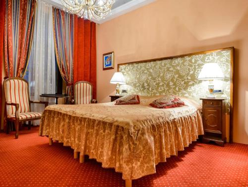 a bedroom with a bed with a large headboard at Hamlet in Dubrovnik