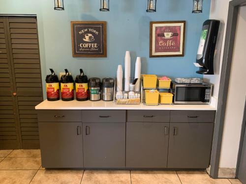 a kitchen with a counter with alcohol bottles on it at Days Inn by Wyndham Louisville Airport Fair and Expo Center in Louisville