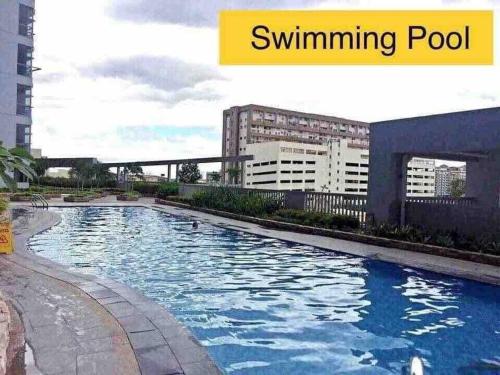 a swimming pool in a city with buildings at Cubao Manhattanheights U24B TD in Manila