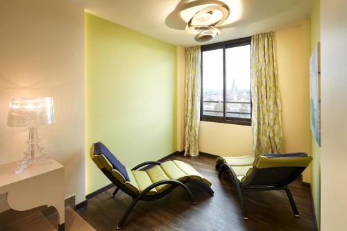 a waiting room with two chairs and a window at Best Western Plus Arosa Hotel in Paderborn