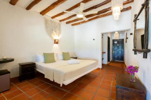 a living room with a white couch in a room at Beachfront Hotel La Palapa - Adults Only in Holbox Island