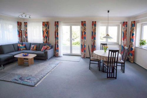 a living room with a couch and a table at Haus Ulla in Bad König