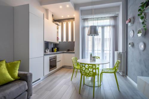 a kitchen and living room with a table and chairs at Green House San Siro in Milan