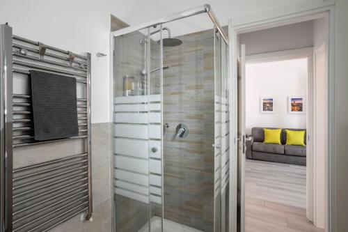 a shower with a glass door in a bathroom at Green House San Siro in Milan