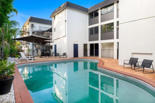a swimming pool in front of a house at Hamilton Brisbane Airport Hotel in Brisbane