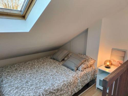 1 dormitorio con cama y ventana en Locanoor Dieppe - Maison de Pêcheur devenue Cosy, en Dieppe
