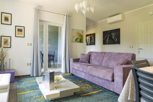 a living room with a purple couch and a table at Luxury Villa Četiri Hrasta in Pićan