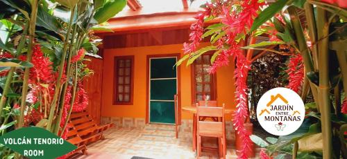 an orange house with a sign in front of it at Jardin entre Montañas in Bijagua