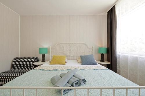 ein Schlafzimmer mit einem großen weißen Bett und einem Stuhl in der Unterkunft Šmuketa in Trogir Haus für 4 Personen in Trogir