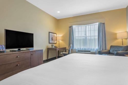 a hotel room with a bed and a flat screen tv at Best Western Plus Liverpool Hotel & Conference Centre in Liverpool