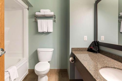 a bathroom with a white toilet and a sink at Best Western Plus Liverpool Hotel & Conference Centre in Liverpool