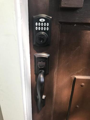 a lock on a door with a security camera at State Street Cottage, Suite 1 in Pullman