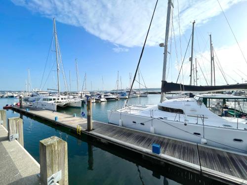 a group of boats docked at a dock at Quay & Sea View Spacious Modern Secure Parking in Poole