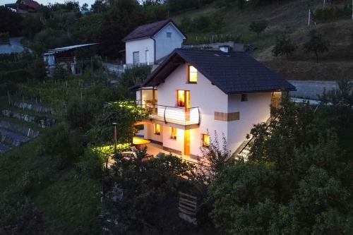 a small white house with lights on a hill at Holiday home in Sentvid pri Sticni - Zentralslowenien 43927 in Šentvid pri Stični