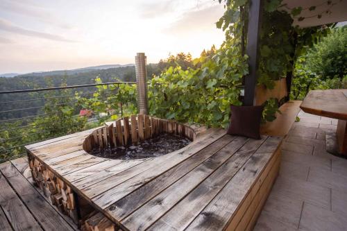 a wooden deck with a fire pit on a balcony at Holiday home in Sentvid pri Sticni - Zentralslowenien 43927 in Šentvid pri Stični