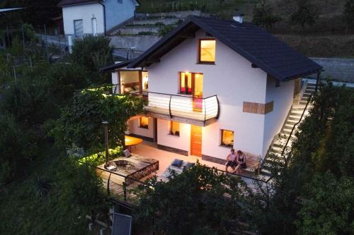 a house with two people sitting on the porch of it at Holiday home in Sentvid pri Sticni - Zentralslowenien 43927 in Šentvid pri Stični