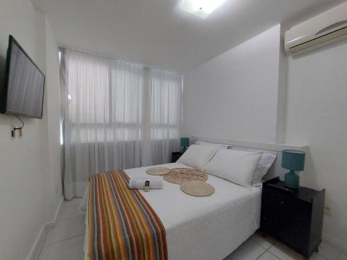 Ένα ή περισσότερα κρεβάτια σε δωμάτιο στο Apartamento encantador no Edifício Manhattan