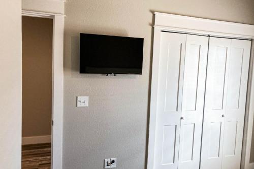 a flat screen tv on a wall next to a door at Pura Vida in Mexico Beach