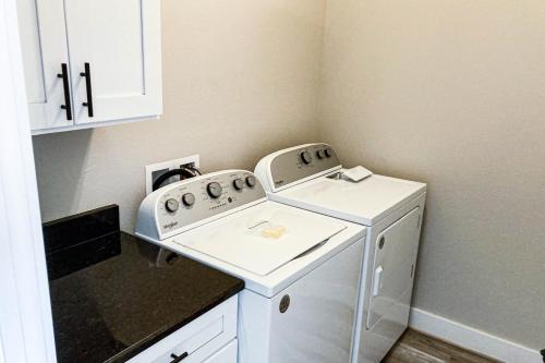 a small laundry room with a washer and dryer at A Slice of Pura Vida in Mexico Beach