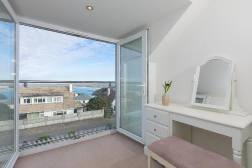 a room with a desk and a large window at Chy Lowen in Carbis Bay