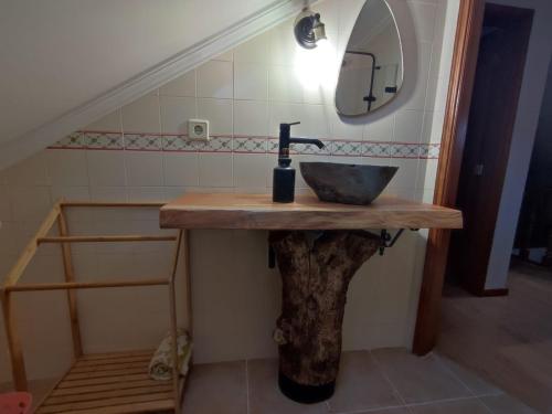 a bathroom with a sink and a mirror at Segredos da Montanha - Seia in Seia