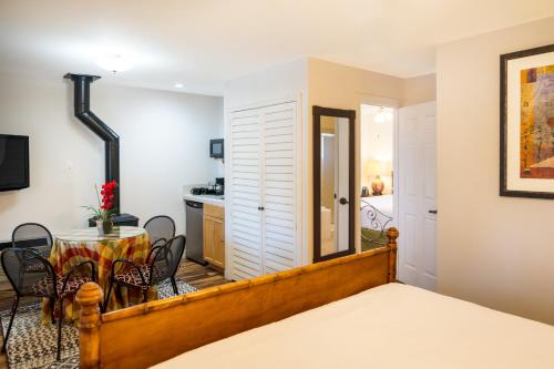 a room with a bed and a table and chairs at The Inn on Pine in Calistoga