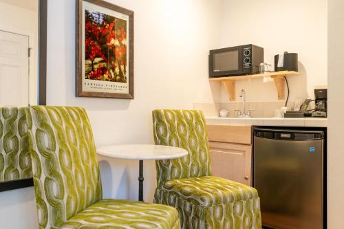 a room with two chairs and a table and a kitchen at The Inn on Pine in Calistoga