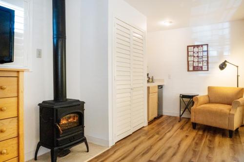 a living room with a stove and a chair at The Inn on Pine in Calistoga