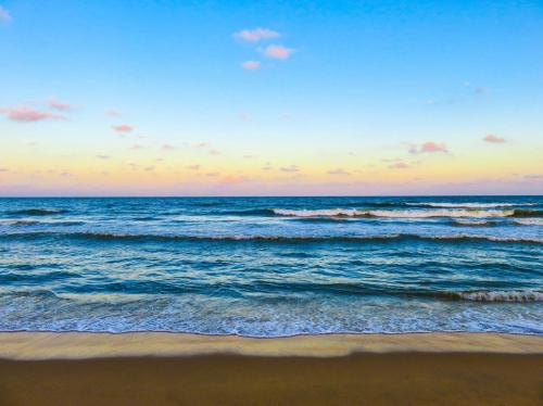 a view of the ocean from the beach at sunset at Lovers Key Resort 1105 in Fort Myers Beach