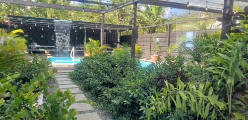 a garden with a swimming pool in a greenhouse at Discovery Beach Apartments in Aguada