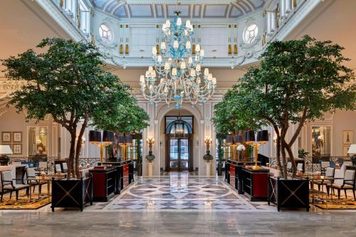 a restaurant with trees in the middle of a lobby at The St. Regis Rome in Rome