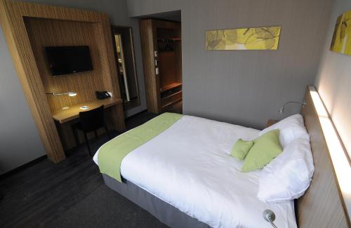 a hotel room with a bed and a desk at BEST WESTERN Hotel Brussels South in Ruisbroek
