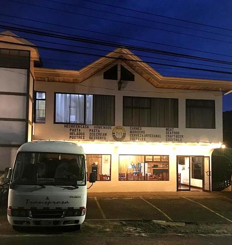 a white van parked in front of a building at Alisson Hotel y Restaurant in Monteverde Costa Rica