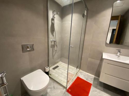 a bathroom with a shower and a toilet and a sink at Corniche Casablanca - Red’s Neuf in Casablanca