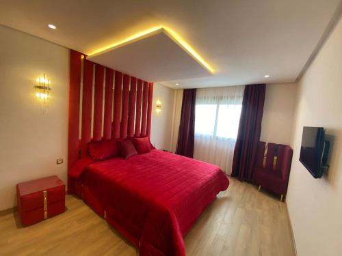 a bedroom with a red bed and a window at Corniche Casablanca - Red’s Neuf in Casablanca