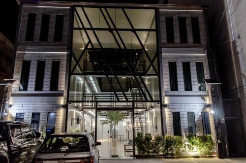 a building with cars parked in front of it at Moriyama Hotel in Mandaue City