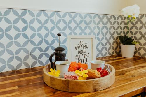 a tray of food on a wooden table with a tray of food at Tai Roto Bay in Arutanga
