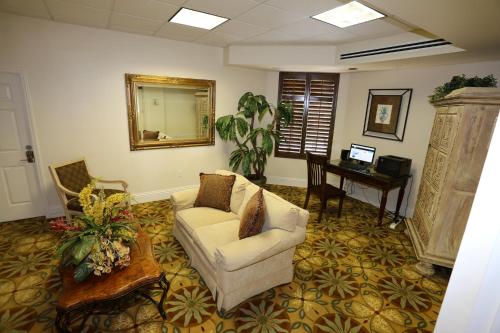 a living room with a couch and a table and a mirror at Lovers Key Resort 403 in Fort Myers Beach