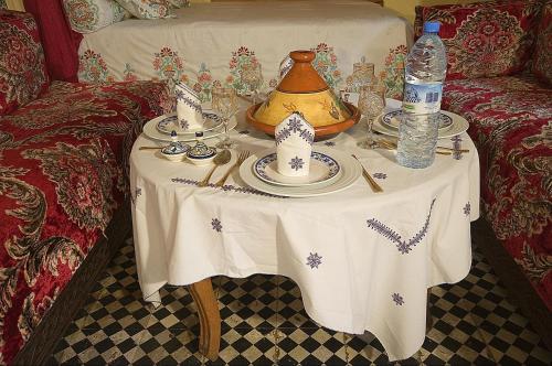a table with a tea pot and plates on it at Riad Dar Jabador in Sale