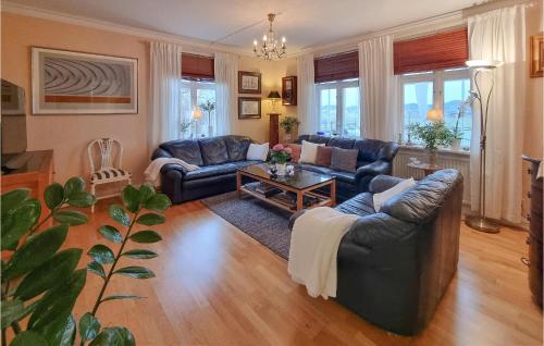 a living room with two couches and a table at 5 Bedroom Pet Friendly Home In Sollebrunn in Sollebrunn