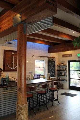 a kitchen with wooden beams and a table and chairs at Haley Hotel in Santa Barbara