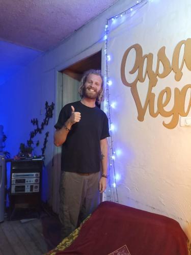 a man standing in a room with a sign at CASA VIEJA del Centro Historico in Quito